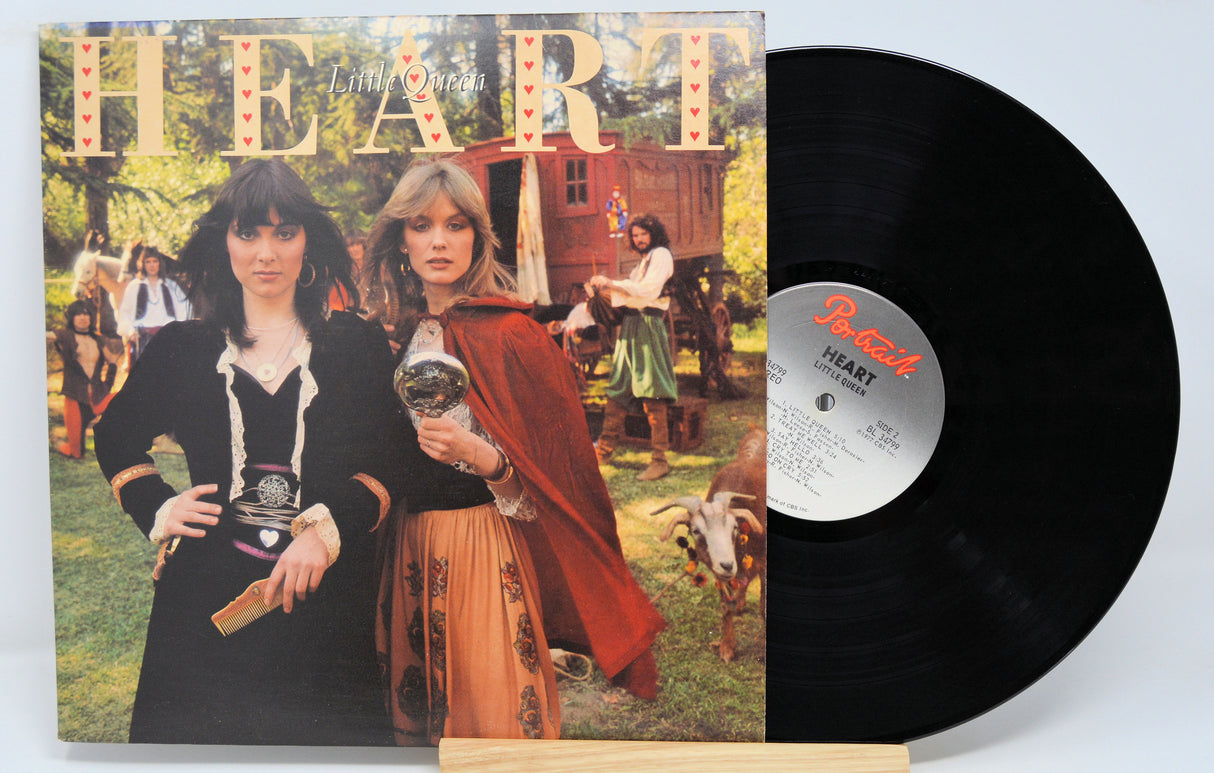 Vinyl record with cover featuring two people in vintage attire on a white background