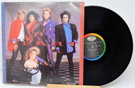Vinyl record with cover featuring a band on a checkered floor background