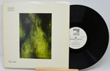 Vinyl record with cover featuring a green abstract design and text.