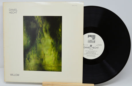 Vinyl record with cover featuring a green abstract design and text.