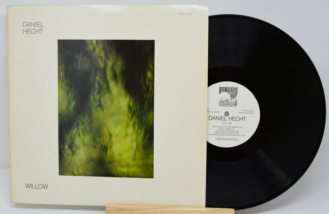 Vinyl record with cover featuring a green abstract design and text.