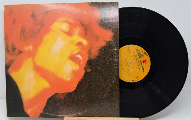Vinyl record with a colorful cover featuring a face and a yellow label.