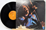 Vinyl record with a colorful cover featuring a person playing an instrument on a white background