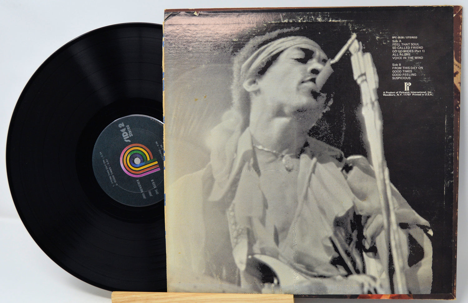 Vinyl record with a black cover featuring a person singing into a microphone.