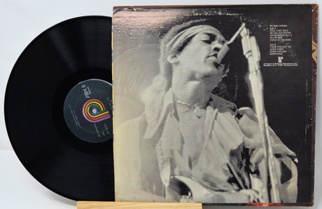 Vinyl record with a black cover featuring a person singing into a microphone.