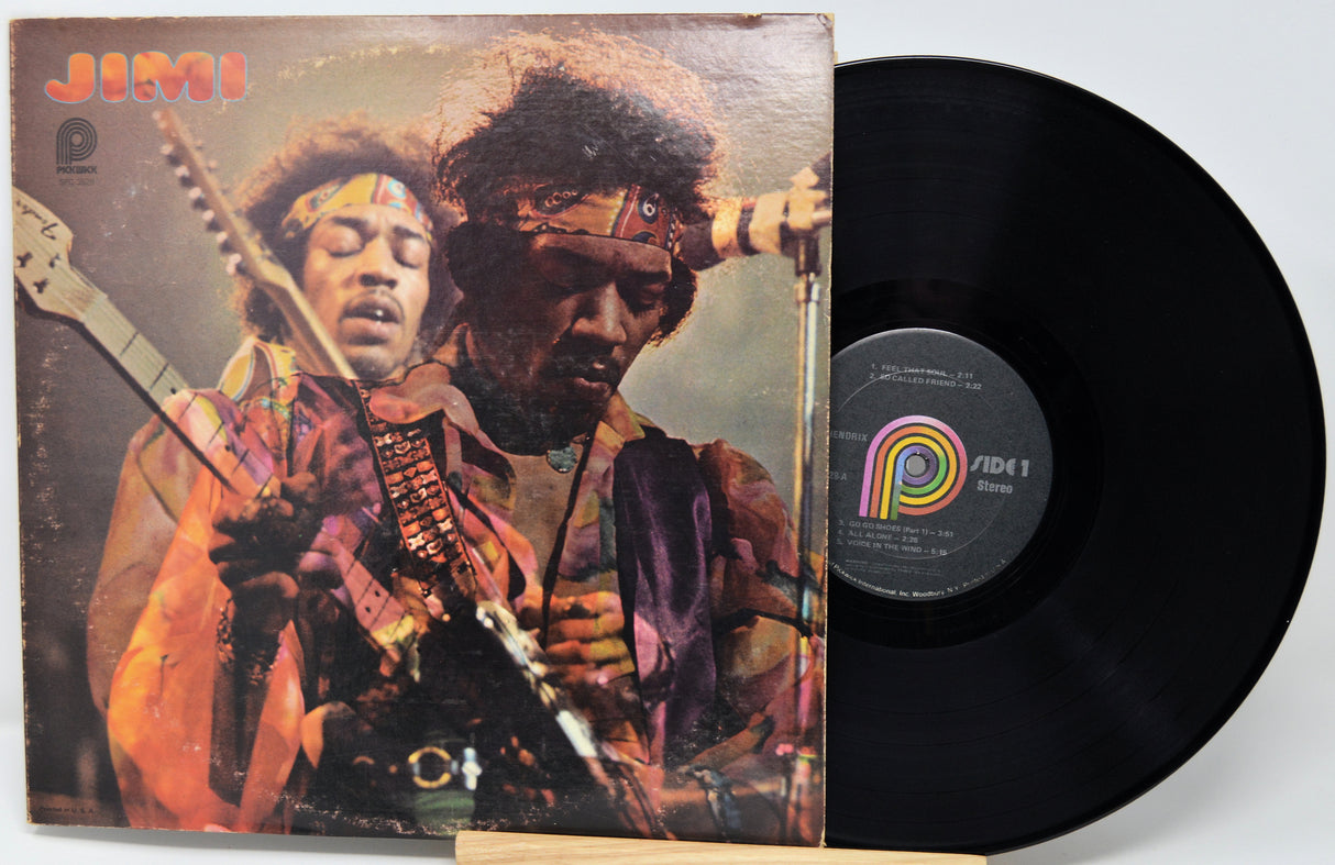 Vinyl record with cover featuring a musician holding a guitar on a white background