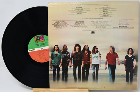 Vinyl record with a cover featuring a group of people on a beach
