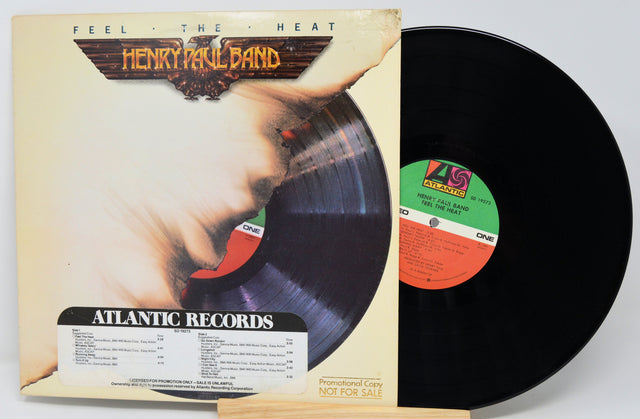 Vinyl record with cover featuring a hand holding a record, labeled 'Henry Paul Band' and 'Atlantic Records'.