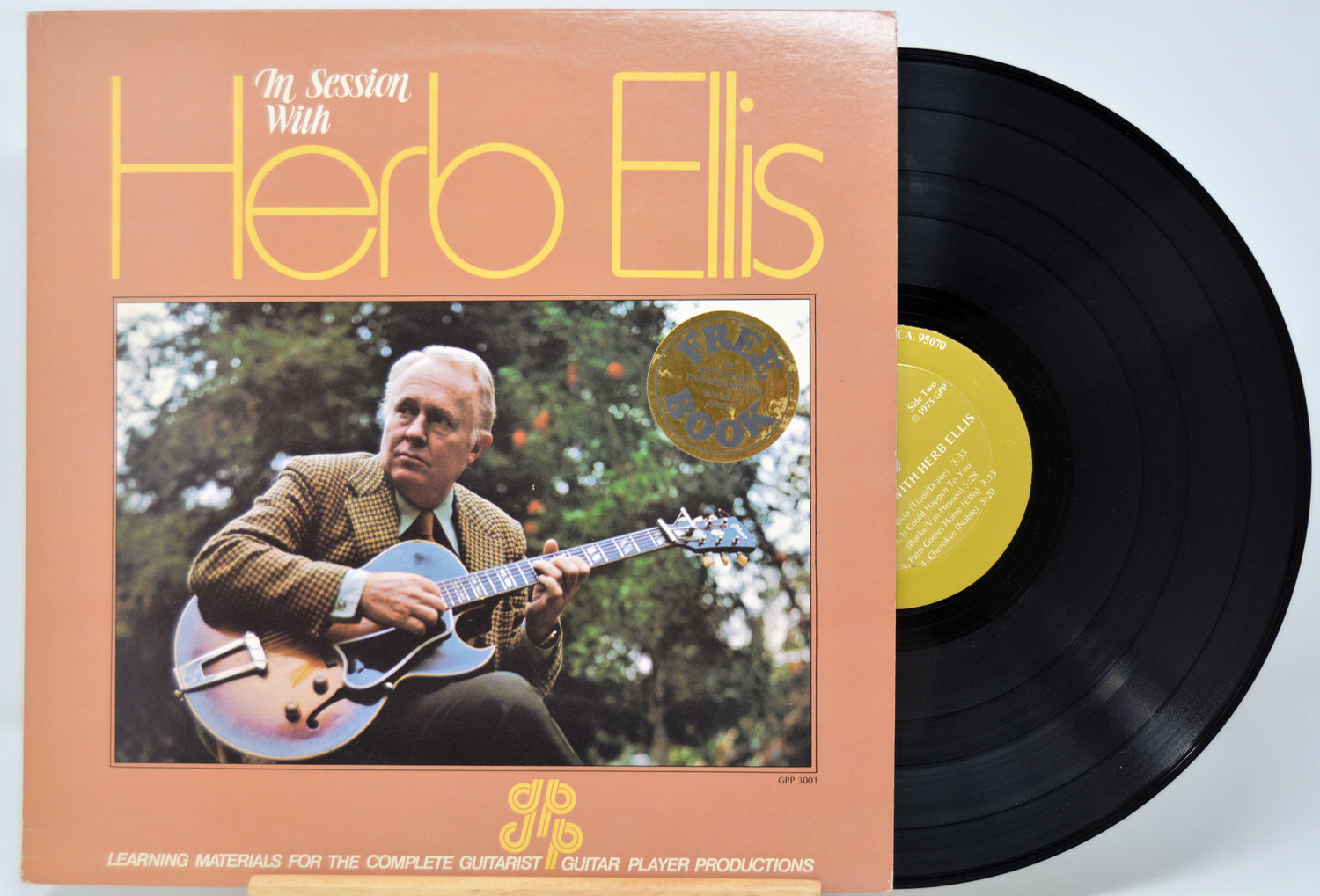 Vinyl record with cover featuring Herb Ellis playing guitar, on a light blue background