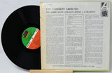 Vinyl record with cover displaying text and a logo on a white background