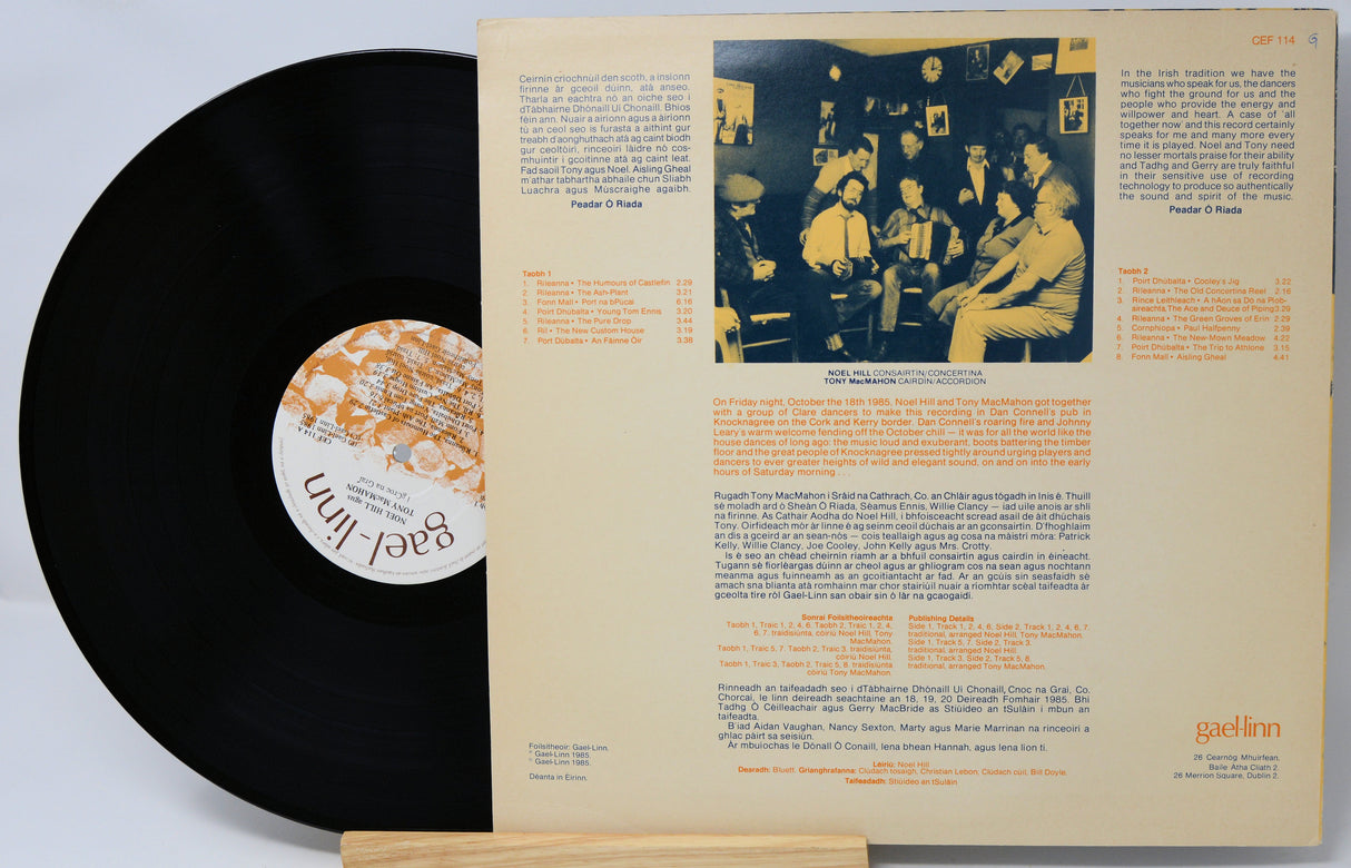 Vinyl record with a detailed cover featuring text and a black and white photo of people.