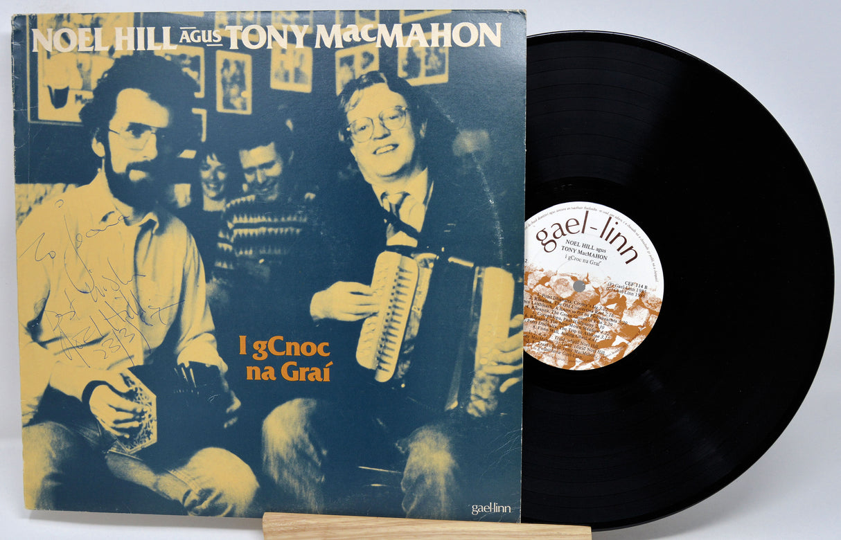 Vinyl record with cover featuring two musicians and text, on a white background