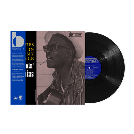 Vinyl record with a cover featuring a person wearing a hat and sunglasses, set against a white background.