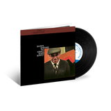 Vinyl record and cover with a man's portrait on a black background