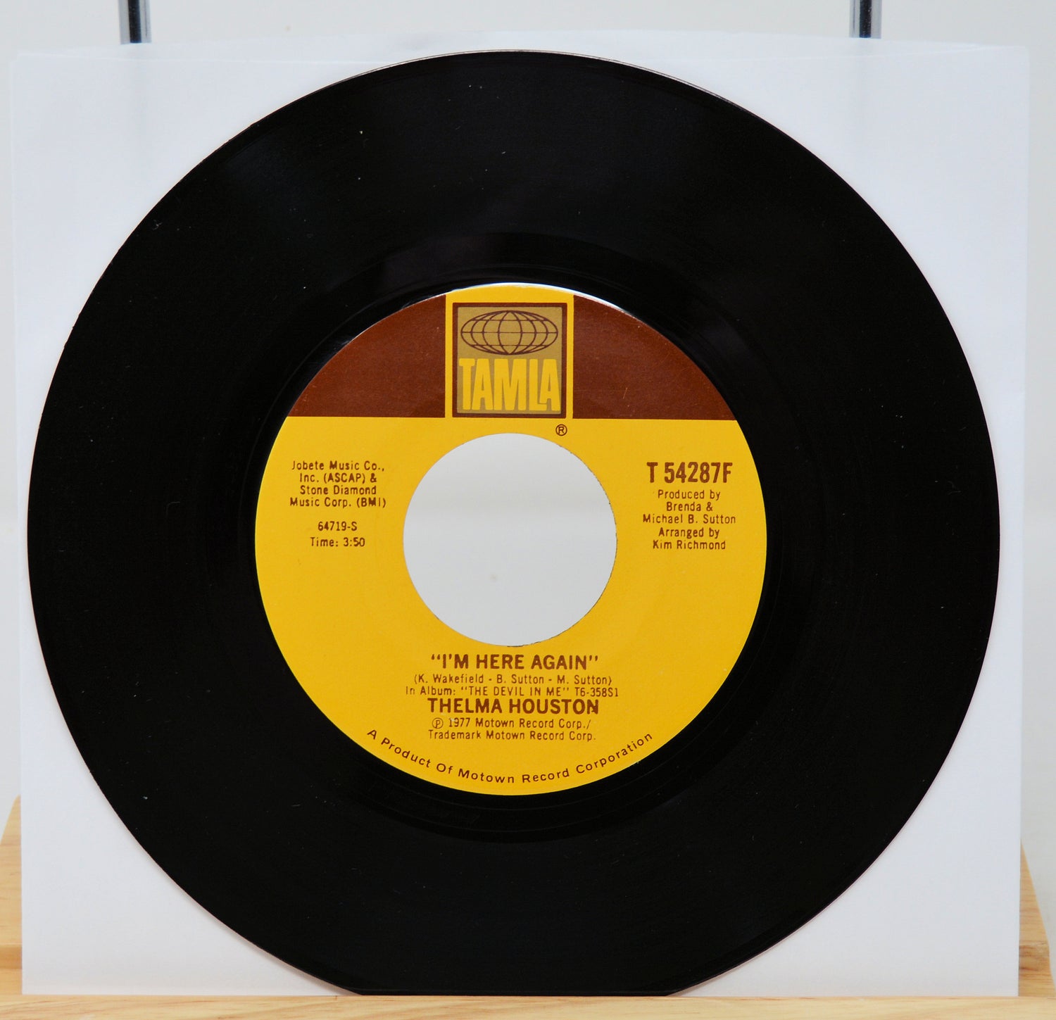 Vinyl record with yellow label on a white background