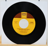 45 RPM record with yellow label on a white background