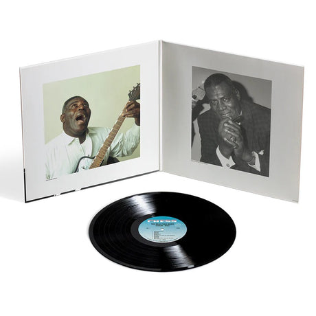 Vinyl record with a white cover featuring black and white photos of a musician playing guitar and singing.