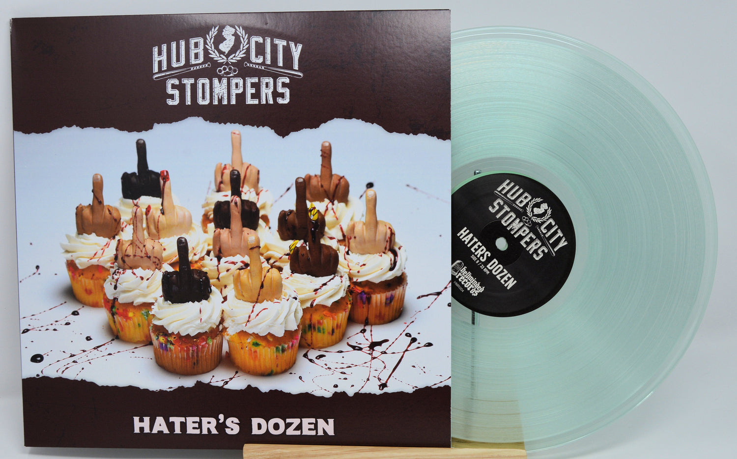 Front cover of Hub City Stompers Hater's Dozen vinyl with colorful cupcakes topped with middle finger decorations