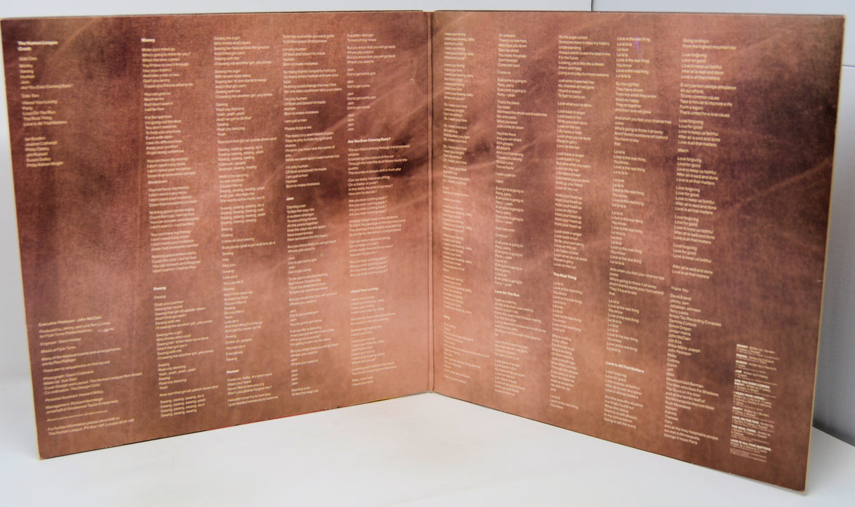 Folded bronze plaque with engraved text on a white background
