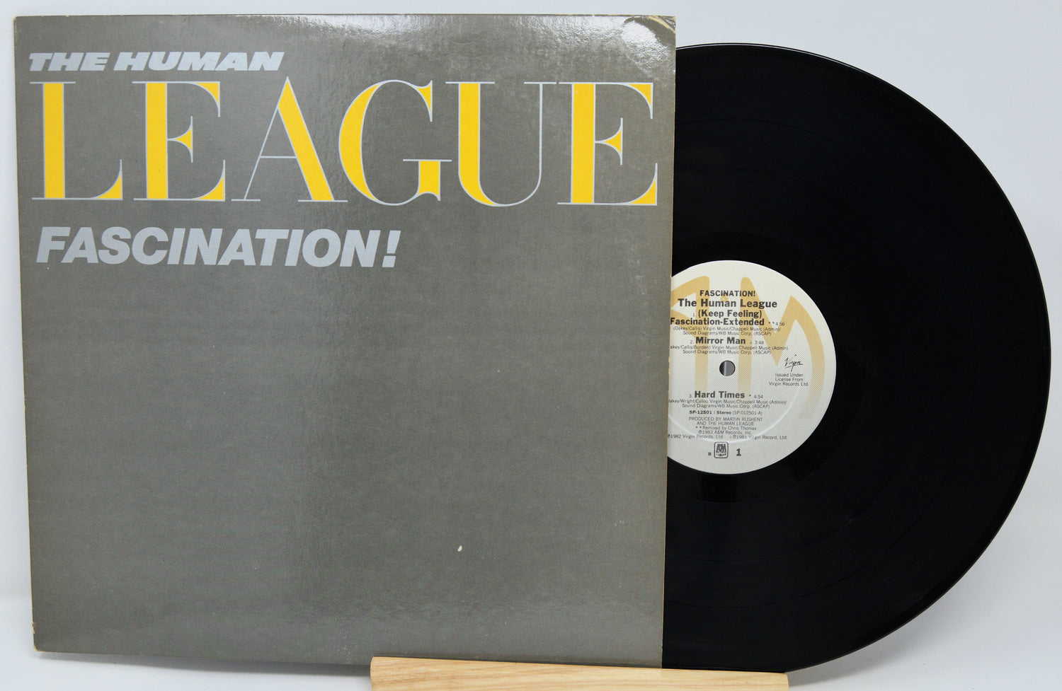 Vinyl record with 'The Human League' album 'Fascination!' on a white background
