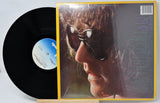 Vinyl record with cover featuring a close-up of a person's face.