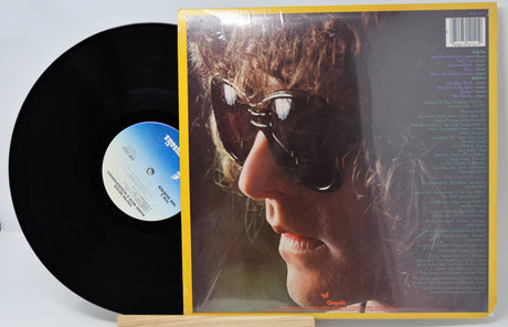 Vinyl record with cover featuring a close-up of a person's face.