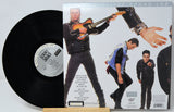 A vinyl record and its back cover from the album 'Weird Al Yankovic: Weird Sound Lab' displayed on a small wooden stand against a white background.