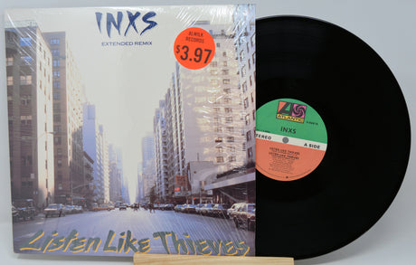 Vinyl record with cover displaying cityscape and 'INXS' branding