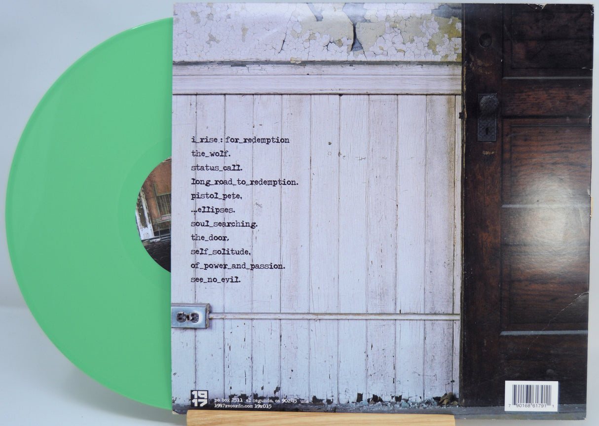 Back cover of I Rise 'For Redemption' green vinyl LP showing tracklist and rustic door