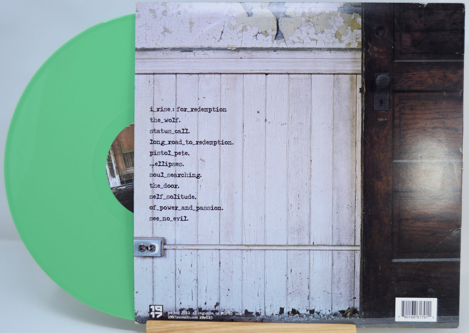 Back cover of I Rise 'For Redemption' green vinyl LP showing tracklist and rustic door