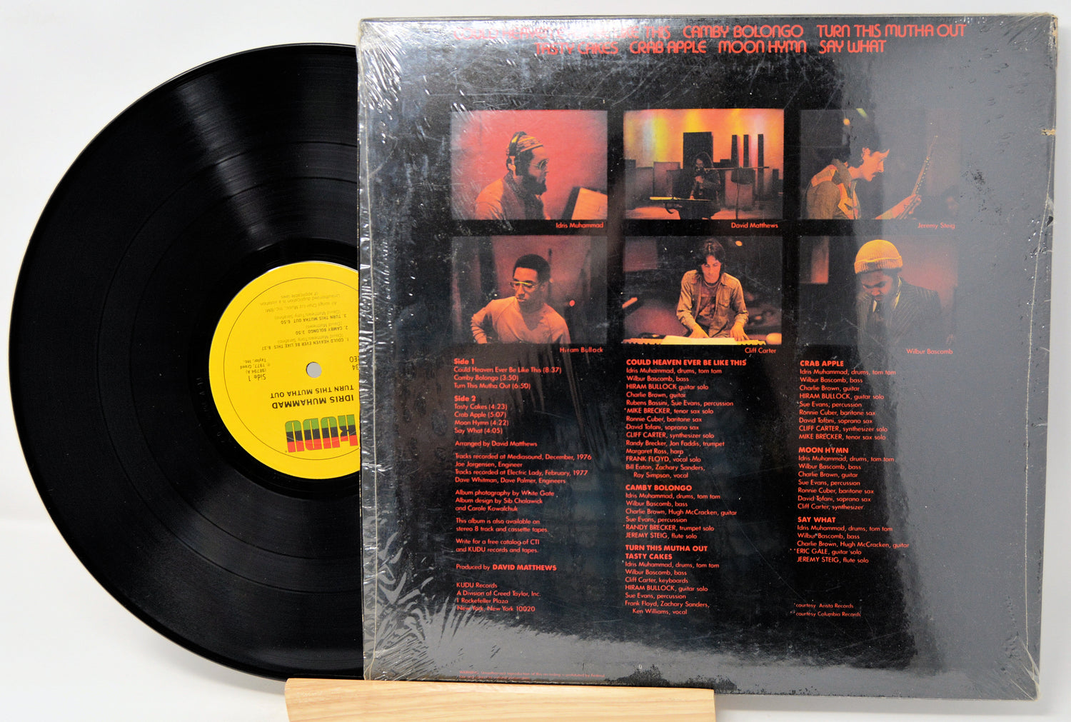 Vinyl record with a yellow label and a cover featuring images and text.