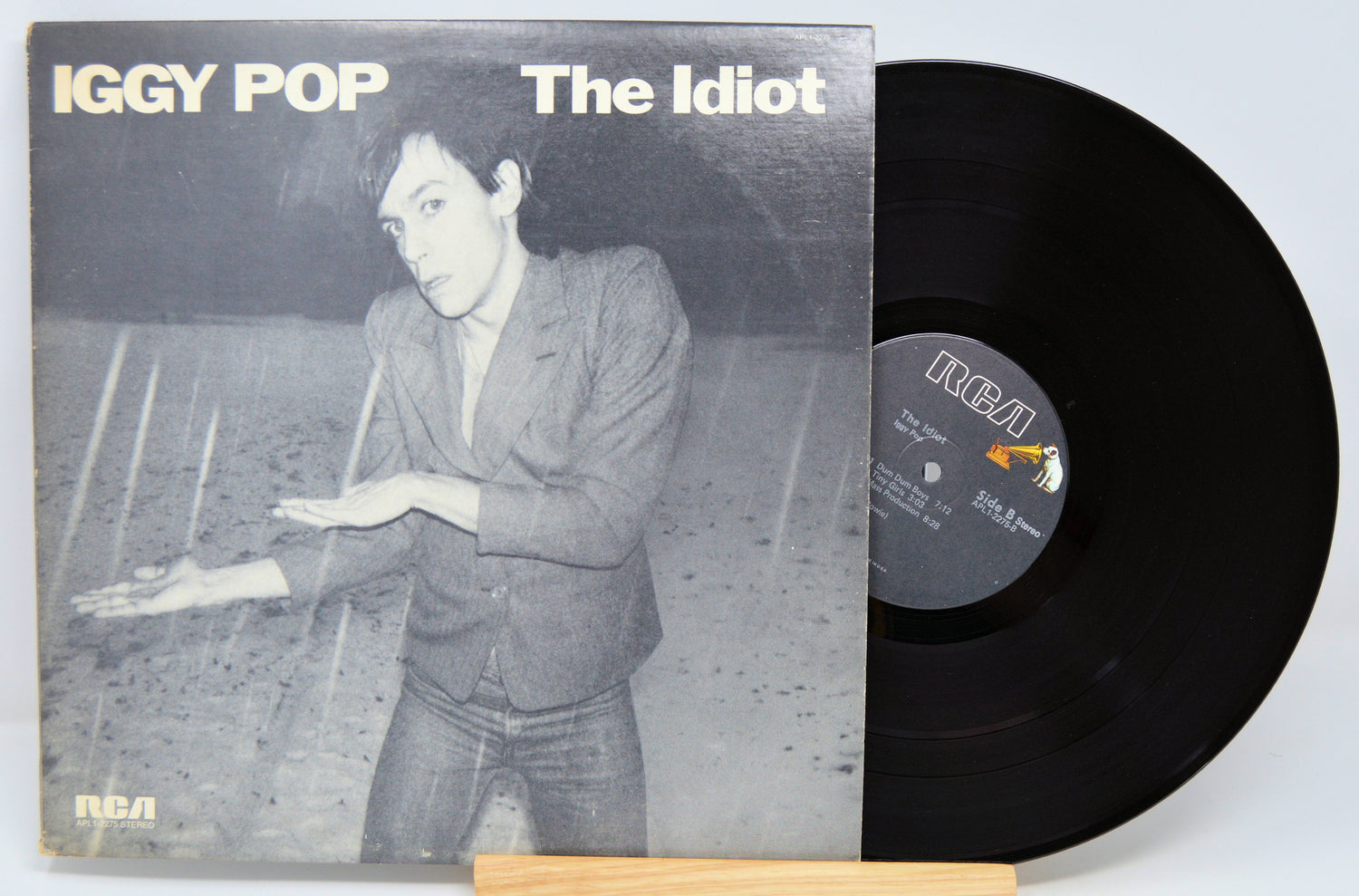 Vinyl record and cover of 'The Idiot' by Iggy Pop on a light gray background