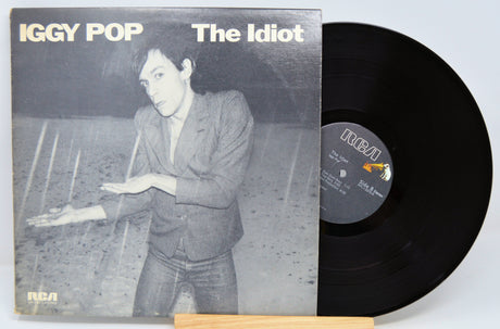 Vinyl record and cover of 'The Idiot' by Iggy Pop on a light gray background