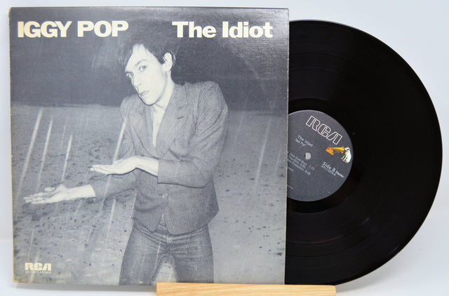 Vinyl record and cover of 'The Idiot' by Iggy Pop on a light gray background