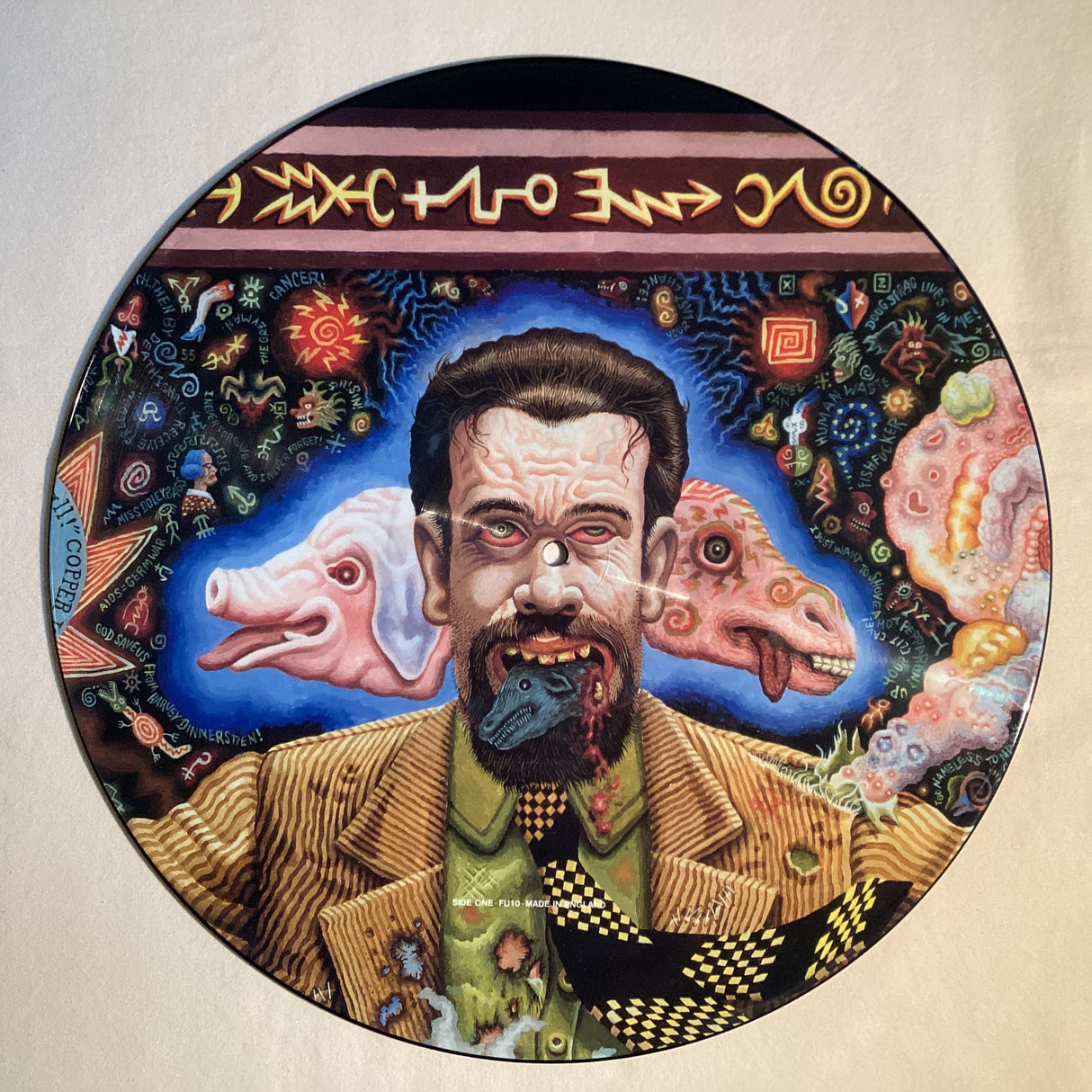 Psychedelic picture disc featuring a bearded man with animal heads and vibrant symbols