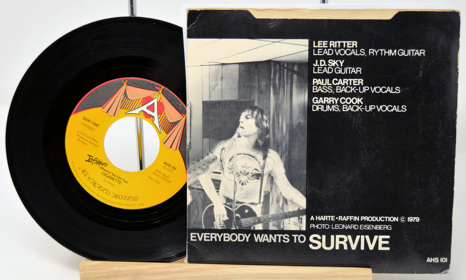 Vinyl record and its cover with text and a black and white photo of a person.