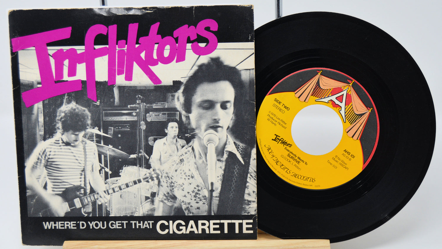 Vinyl record with cover featuring a band and text 'Inffliktors' on a white background