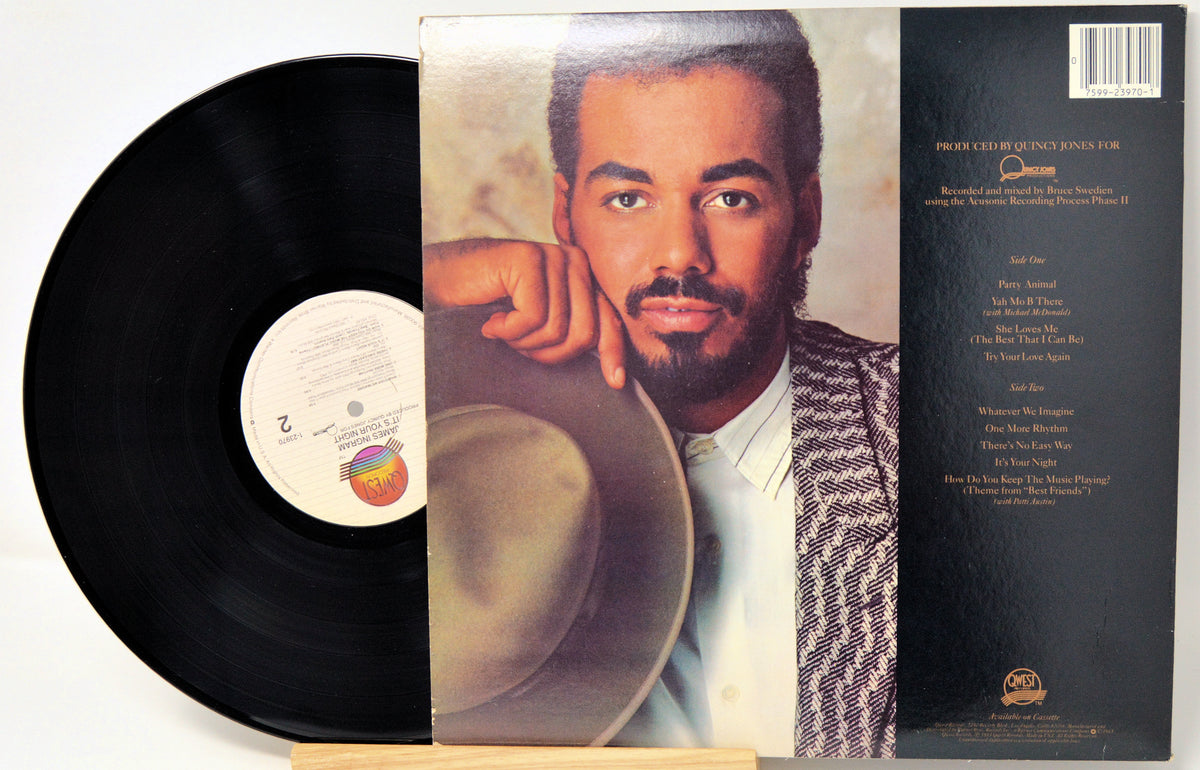 A vinyl record album shown with the black record partially pulled from its sleeve, featuring a portrait of a man on the front cover and track listing text on the back, photographed on a white background.