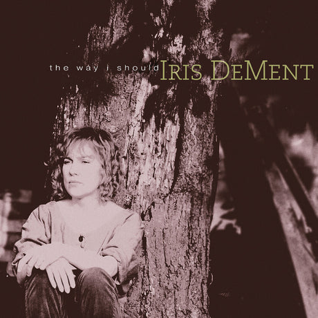 Album cover with a person sitting against a tree, featuring text 'the way i should' and 'Iris Dement'.