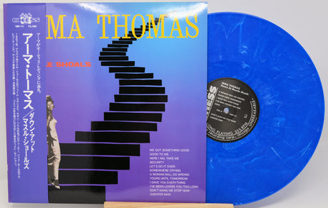 A vinyl record album for Ma Thomas's '2 Shoes' shown with its illustrated cover sleeve and a translucent blue vinyl disc partially pulled out. The cover features a purple-to-blue gradient background with black stairs and yellow text.
