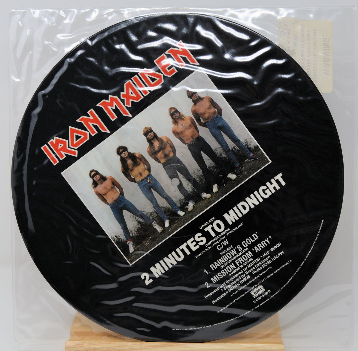 Vinyl record with Iron Maiden cover art on a white background