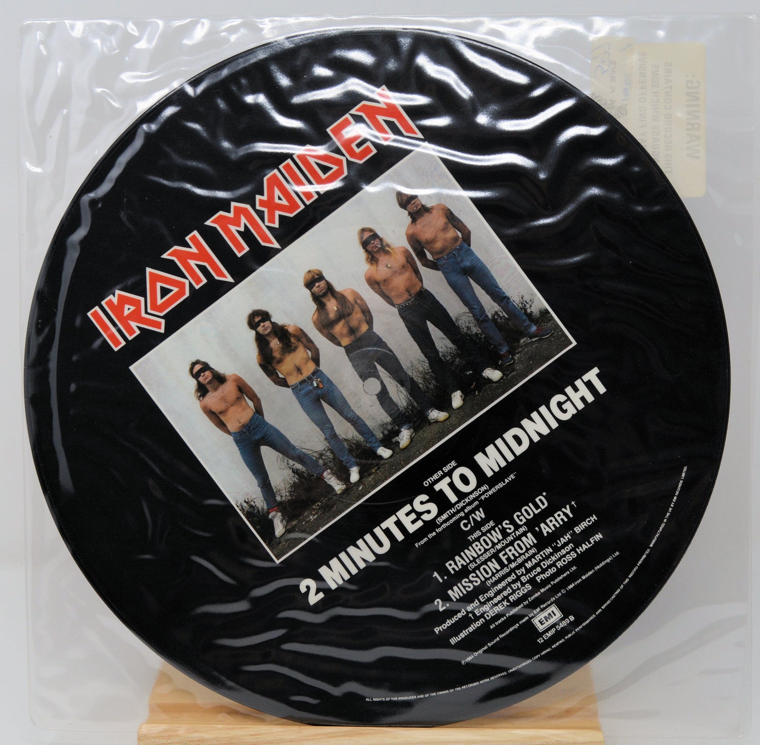 Vinyl record with Iron Maiden cover art on a white background