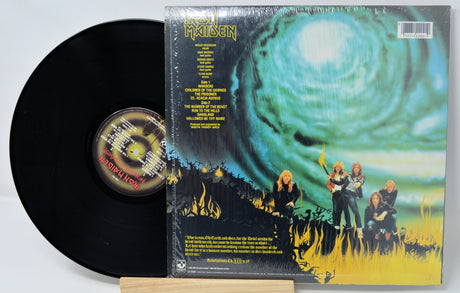Vinyl record with its cover featuring a cosmic design and characters around a campfire.