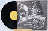 Vinyl record with a gatefold cover featuring band members and a live performance.