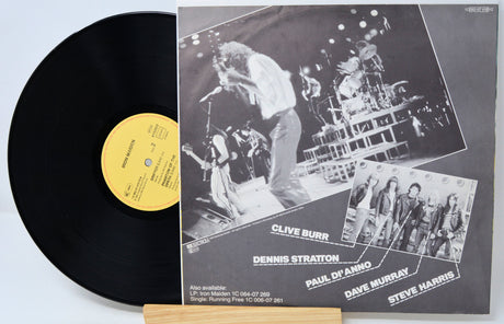 Vinyl record with a gatefold cover featuring band members and a live performance.