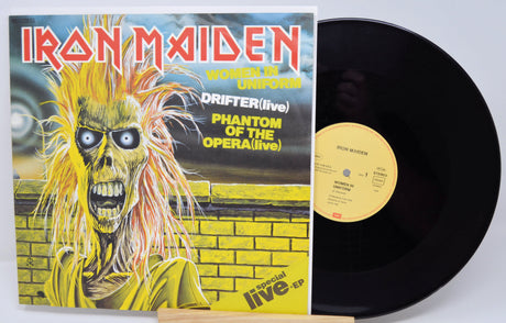 Vinyl record with Iron Maiden cover featuring a skeleton in a yellow suit.