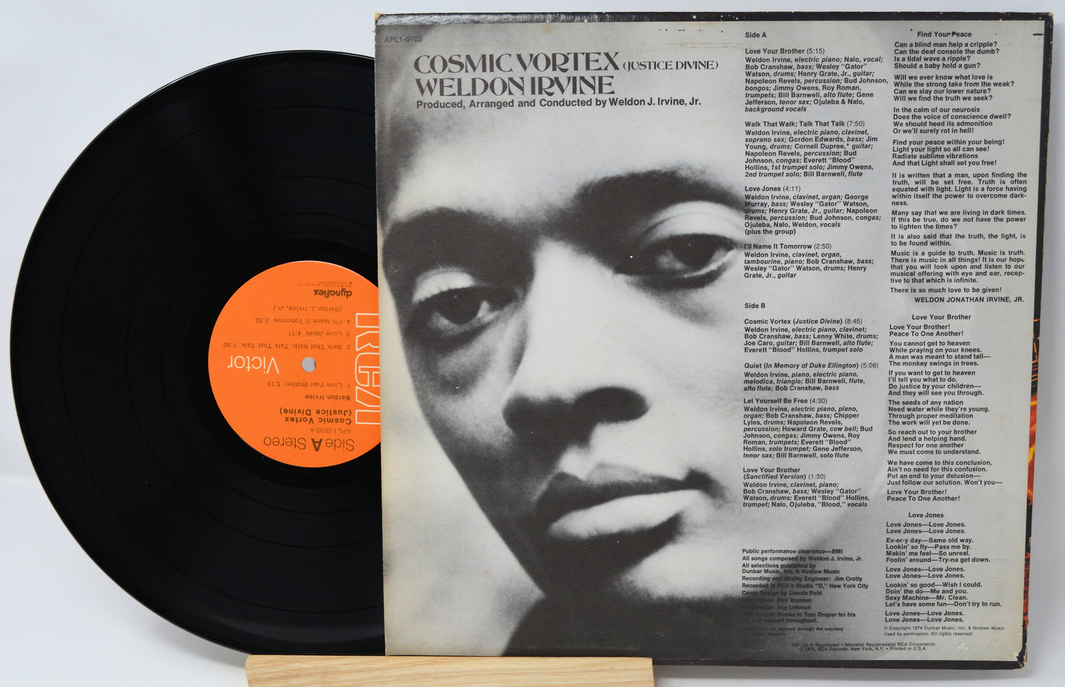 Vinyl record with a black and white portrait on the cover and an orange label.
