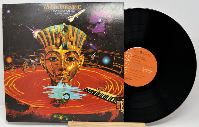 Vinyl record with a colorful cover featuring an Egyptian-style mask and space-themed elements.