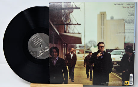 Vinyl record with cover featuring a group of people on a street scene