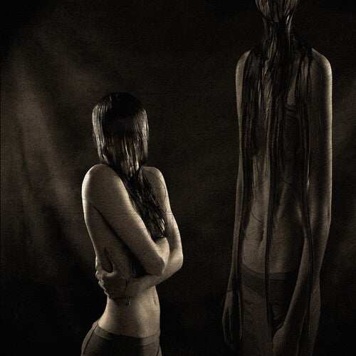 Two figures in a dark, moody setting with one figure partially obscured by hair.